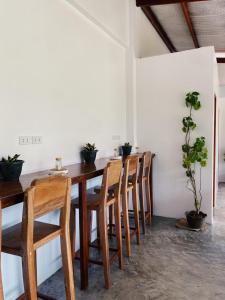 a dining room with a wooden table and chairs at TangboSurfHouse in Alegria +12 photos