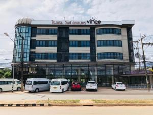 a building with cars parked in a parking lot at Vince Sakon in Sakon Nakhon