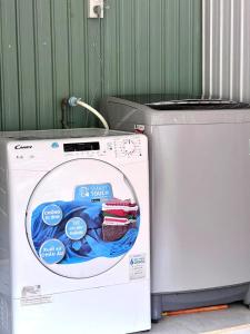 a washing machine with a sticker on the front of it at Roxie home view thung lũng,săn mây, gần trung tâm in Xuan An