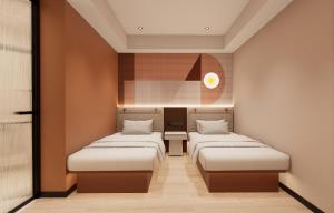 a room with three beds in a room at A Hotel Farrer Park - Newly Renovated in Singapore +8 photos