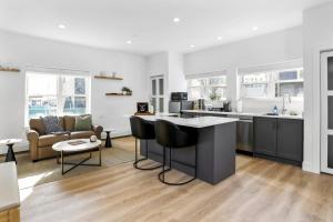 a kitchen and living room with a island in the middle at Harbor Haven, Apt #1 - Studio in Stamford