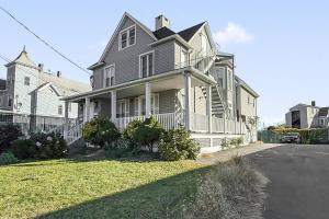 a large house with a white fence on a street at Harbor Haven, Apt #1 - Studio in Stamford