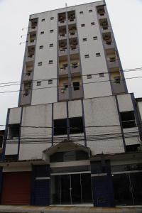 a tall building with windows on the side of it at Comfoort Hotel in Volta Redonda