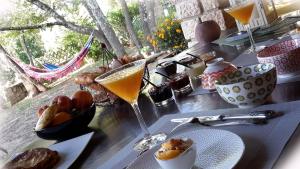 a table with a drink and some food on it at Om'Sleeping B&B in Laudun