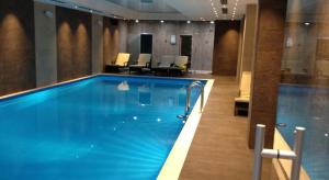 a large swimming pool in a hotel room at Ana Apartment at Orbi in Bakuriani