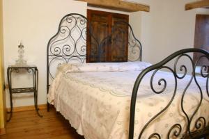 a bedroom with a bed with a metal frame at Bed and Breakfast San Firmano in Montelupone