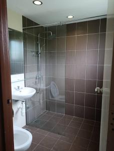 a bathroom with a shower and a toilet and a sink at Casa Melaka in Kampong Pulau Sebang