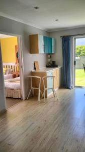 a kitchen with a desk and a bed in a room at Da Capo in Bettyʼs Bay