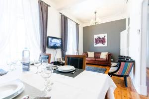 a living room with a white table with wine glasses at Luxury Apartment in City Centre - Avenida da Liberdade in Lisbon