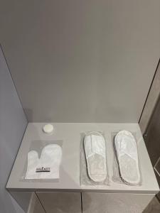 a white shelf with two pairs of shoes on it at Studio Leszczyńskiego Przemyśl in Przemyśl +58 photos