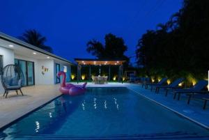 a swimming pool with a pink flamingo in the middle at Viva La Villa in Highland Lakes
