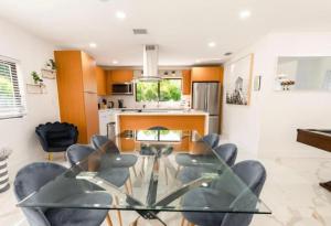 a living room with a glass table and chairs at Viva La Villa in Highland Lakes +4 photos