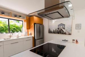 a kitchen with a sink and a refrigerator at Viva La Villa in Highland Lakes