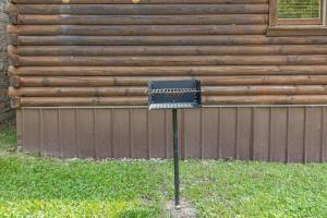 a black mailbox sitting in the grass in front of a building at WiFi - Dreamcatcher - Lux-Tiny Cabin in RRG KY in Rogers