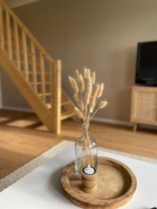 a vase with a plant in it on a table at Brockenblick  +18 photos