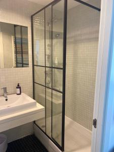 a bathroom with a glass shower and a sink at Red 4 x 4 in Camarma de Esteruelas