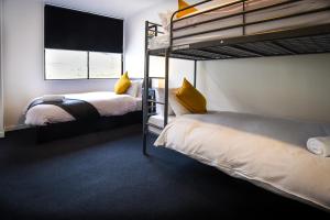 a bedroom with two bunk beds and a window at The Phat Palace in Otari