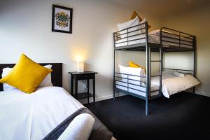 a bedroom with two bunk beds and a bed at The Phat Palace in Otari