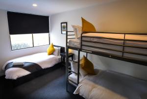 a room with two bunk beds and a window at The Phat Palace in Otari