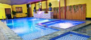 a large swimming pool in a room with at Lolo's Staycation in Tinajeros