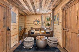 a living room with a couch and a table at Treehouse - Amazonia - Red River Gorge KY in Rogers