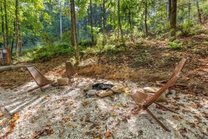three chairs sitting on the ground in the woods at Treehouse - Amazonia - Red River Gorge KY in Rogers