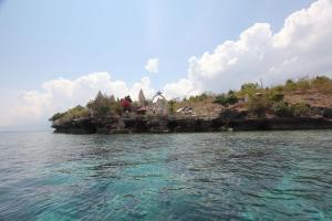 an island in the middle of the water at Pondok Dhevika and Warung in Pemuteran