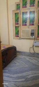 a bedroom with a bed and a window with a air conditioner at Devaa Homstay in Mau