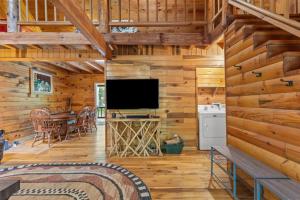 a living room with a television and a dining room at WiFi & Pet Friendly - The Road's End in Rogers