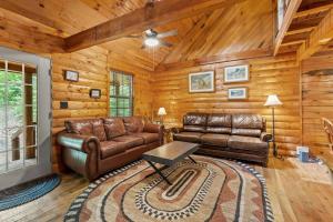 a living room with a leather couch and a table at WiFi & Pet Friendly - The Road's End in Rogers +24 photos