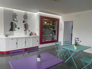 a dining room with a purple table and chairs at Il Castelluccio in Arezzo