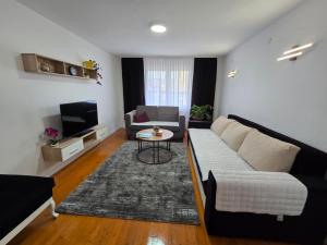 a living room with a couch and a table at Apartman SAN in Sarajevo