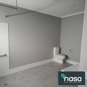 a white bathroom with a toilet and a shower at Milbridge Getaway with a bathroom in each room in Eaton