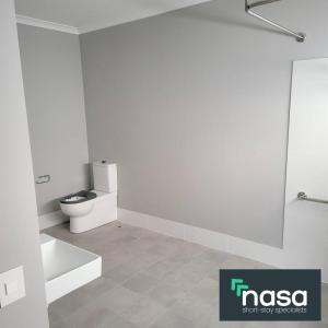 a white bathroom with a toilet and a sink at Milbridge Getaway with a bathroom in each room in Eaton +5 photos