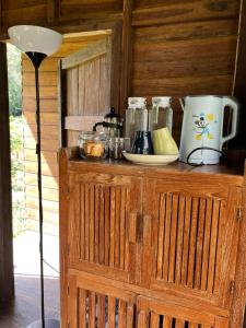 a wooden cabinet with a coffee maker on top of it at Homebar in Ko Chang
