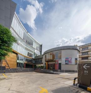 a large building with a street sign in front of it at Aspira Petchkasem in Ban Khlong Om Noi