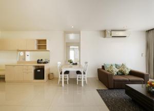 a living room with a couch and a table at Aspira Petchkasem in Ban Khlong Om Noi