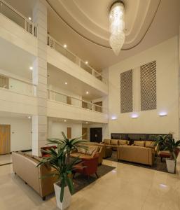 a lobby with couches and tables and a chandelier at Aspira Petchkasem in Ban Khlong Om Noi