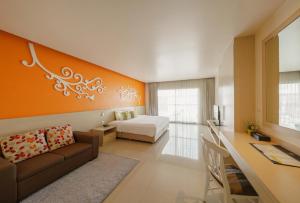 a hotel room with a couch and a bed and a desk at Aspira Petchkasem in Ban Khlong Om Noi +29 photos