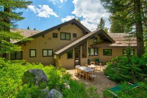 a house with a deck and a patio at RMR: Sublette Ridge Ski Lodge in Teton Village in Teton Village