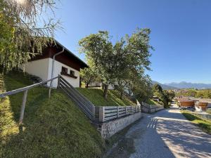 a house with a fence next to a road at Holiday home with panoramic view in Kleinvolderberg