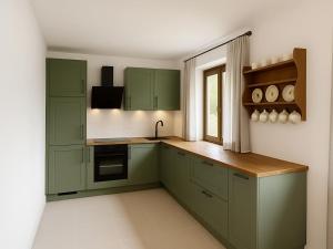 a kitchen with green cabinets and a window at Holiday home with panoramic view in Kleinvolderberg