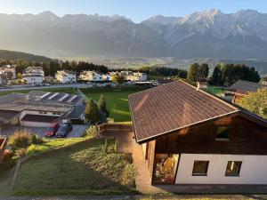 a view of a house with mountains in the background at Holiday home with panoramic view in Kleinvolderberg +9 photos