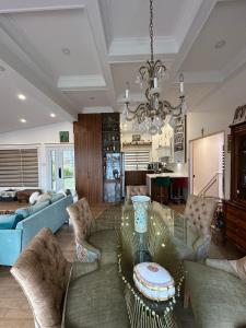 a living room with a glass table and chairs at Aqua Luxury House on the Shore in Laval