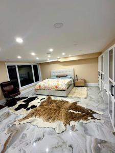 a bedroom with a cow rug on the floor at Aqua Luxury House on the Shore in Laval +11 photos