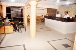 un grupo de personas sentadas en un bar en un restaurante en Hotel Swiss Garden International, en Chittagong