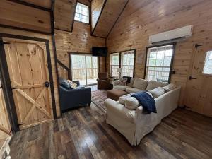 a living room with a couch and chairs and a door at WiFi & Hot Tub Large Family - Climb On in RRG in Rogers