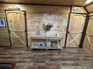 a room with two wooden doors and a table at WiFi & Hot Tub Large Family - Climb On in RRG in Rogers