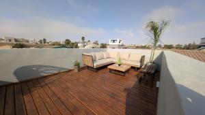 a patio with a couch on a wooden deck at Amarachi Guesthouse in Swakopmund