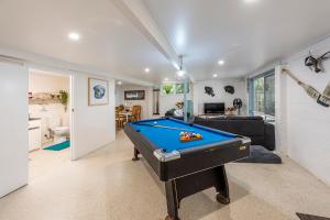 a living room with a pool table in it at Pet friendly beachfront home- sleeps 8 in Toogoom